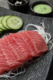 Photo of Tasty sashimi (pieces of fresh raw tuna) and glass noodles on plate, closeup