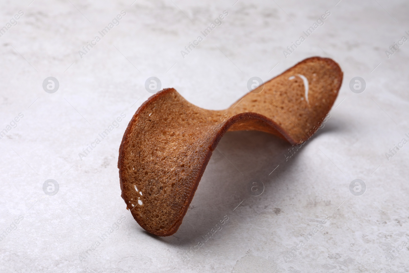 Photo of Crispy rusk on light table. Tasty snack