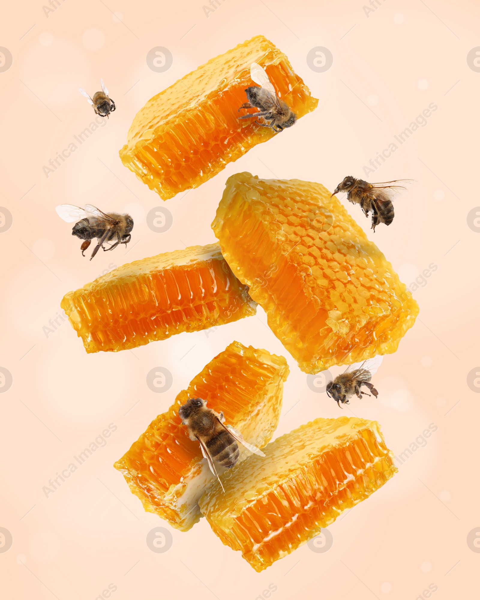 Image of Pieces of honeycomb in air and bees flying on beige background, bokeh effect