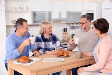 Photo of Happy senior couples spending time together at home