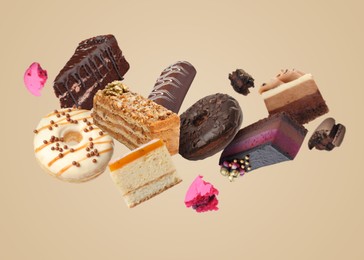 Image of Many different tasty desserts flying on beige background