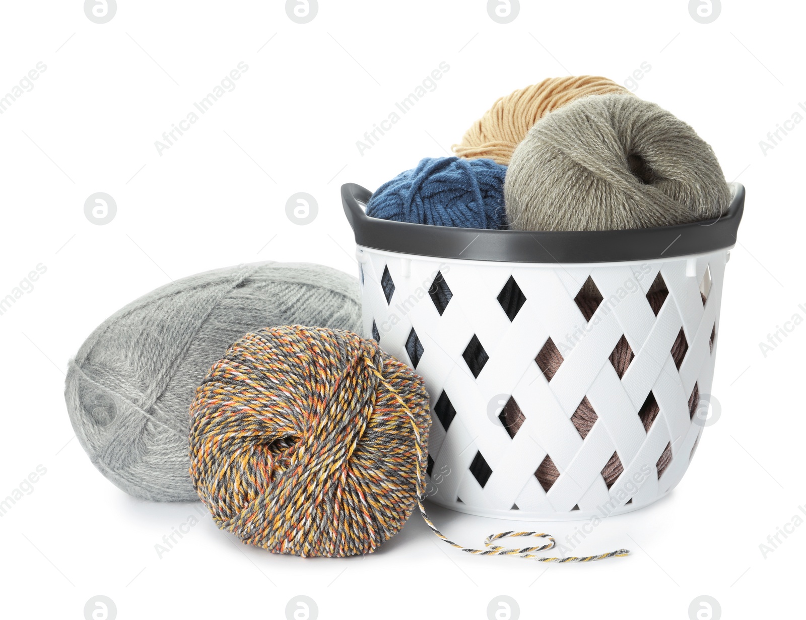 Photo of Basket with different balls of woolen knitting yarns on white background