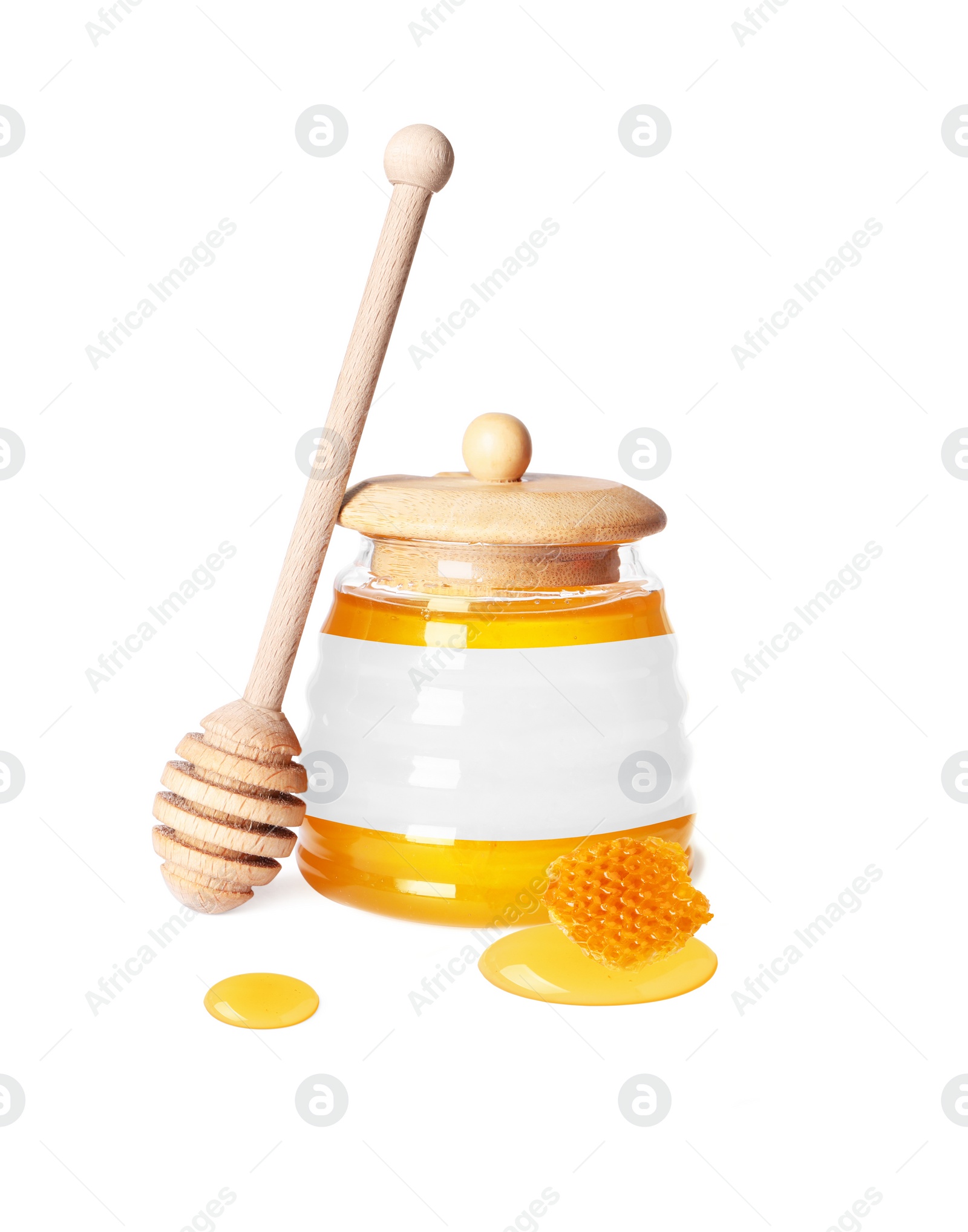 Image of Sweet honey in glass jar with blank label, wooden honey dipper and piece of honeycomb on white background. Mockup for design