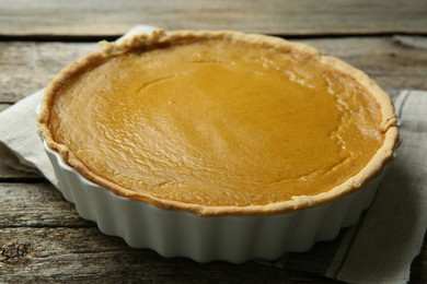 Delicious pumpkin pie on wooden table, closeup