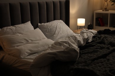 Soft bed, nightlight and cozy furniture indoors