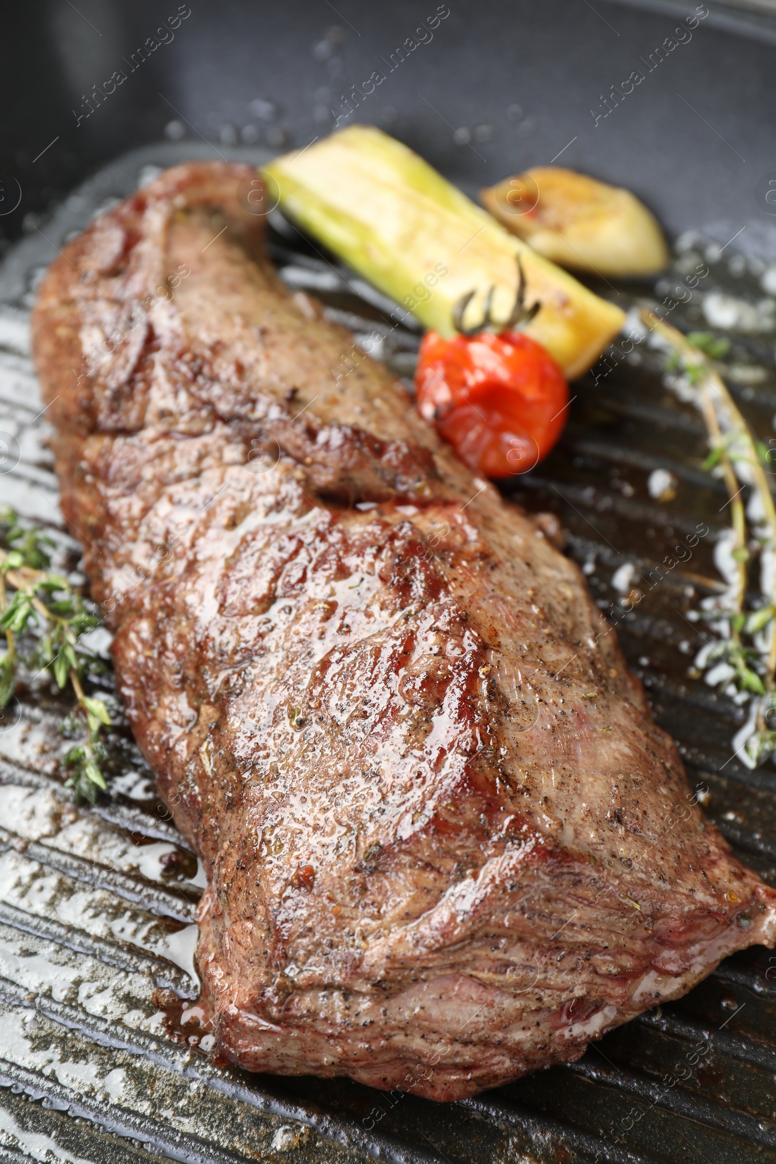 Photo of Delicious grilled beef meat and vegetables in pan, closeup