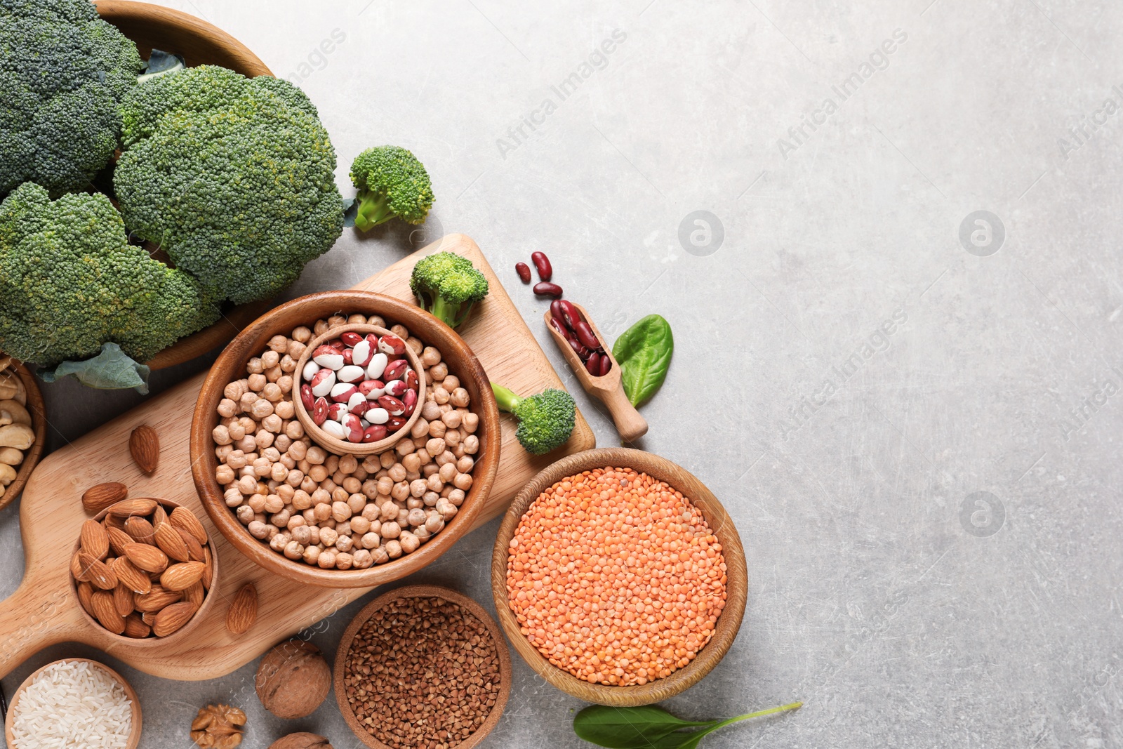Photo of Set of natural food high in protein and space for text on grey background, top view