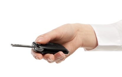 Woman holding car key isolated on white