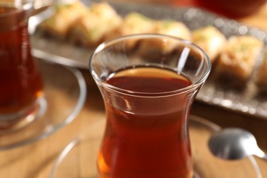 Photo of Traditional Turkish tea in glasses on table, closeup