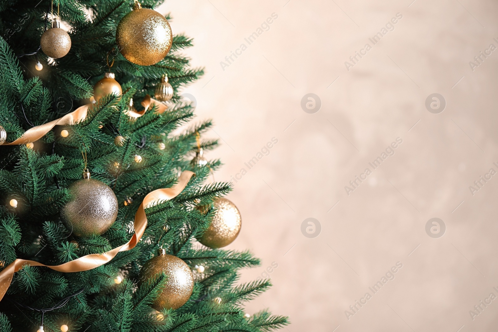 Photo of Beautiful Christmas tree with decor on light background. Space for text