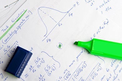 Photo of Paper with written mathematical calculations and green highlighter, top view