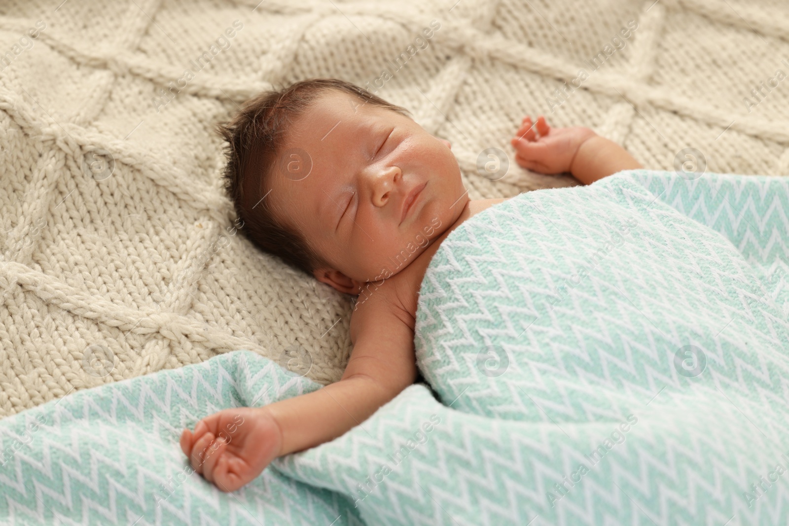 Photo of Cute newborn baby sleeping on beige blanket, closeup