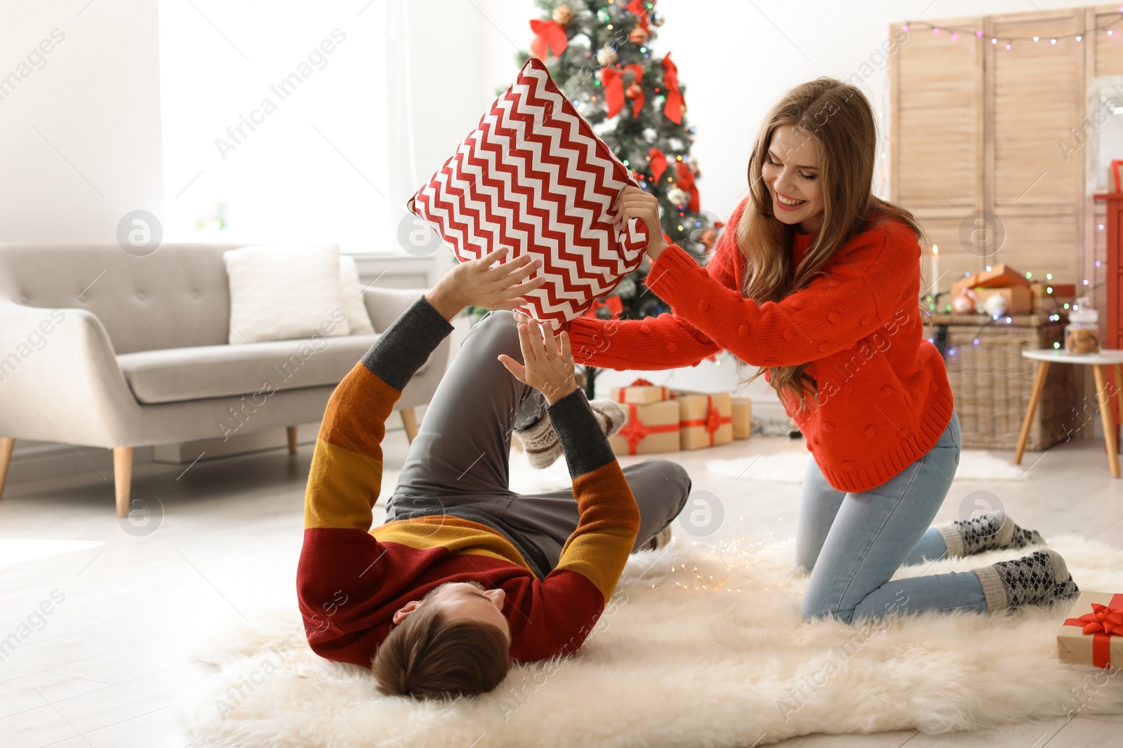 Photo of Happy young couple having fun on Christmas day at home