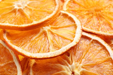 Photo of Delicious dry orange slices as background, closeup