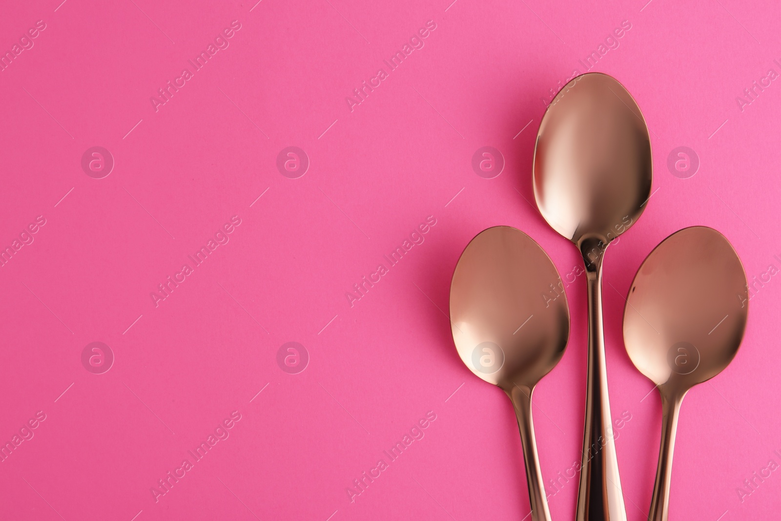 Photo of Flat lay composition with clean tea spoons and space for text on color background