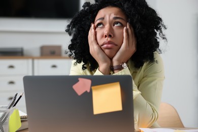 Deadline concept. Stressed woman near laptop in office