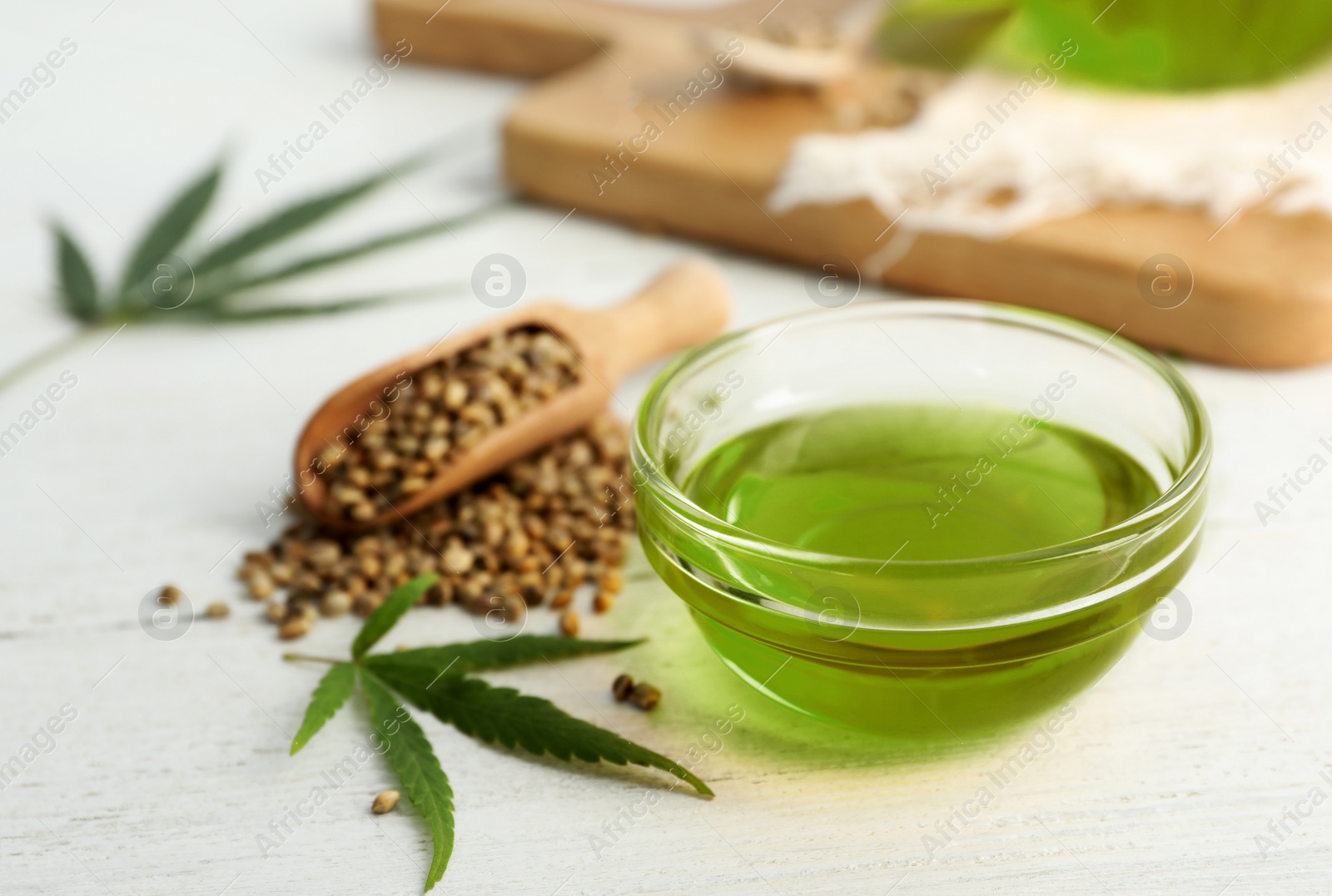 Photo of Composition with hemp oil on white wooden table