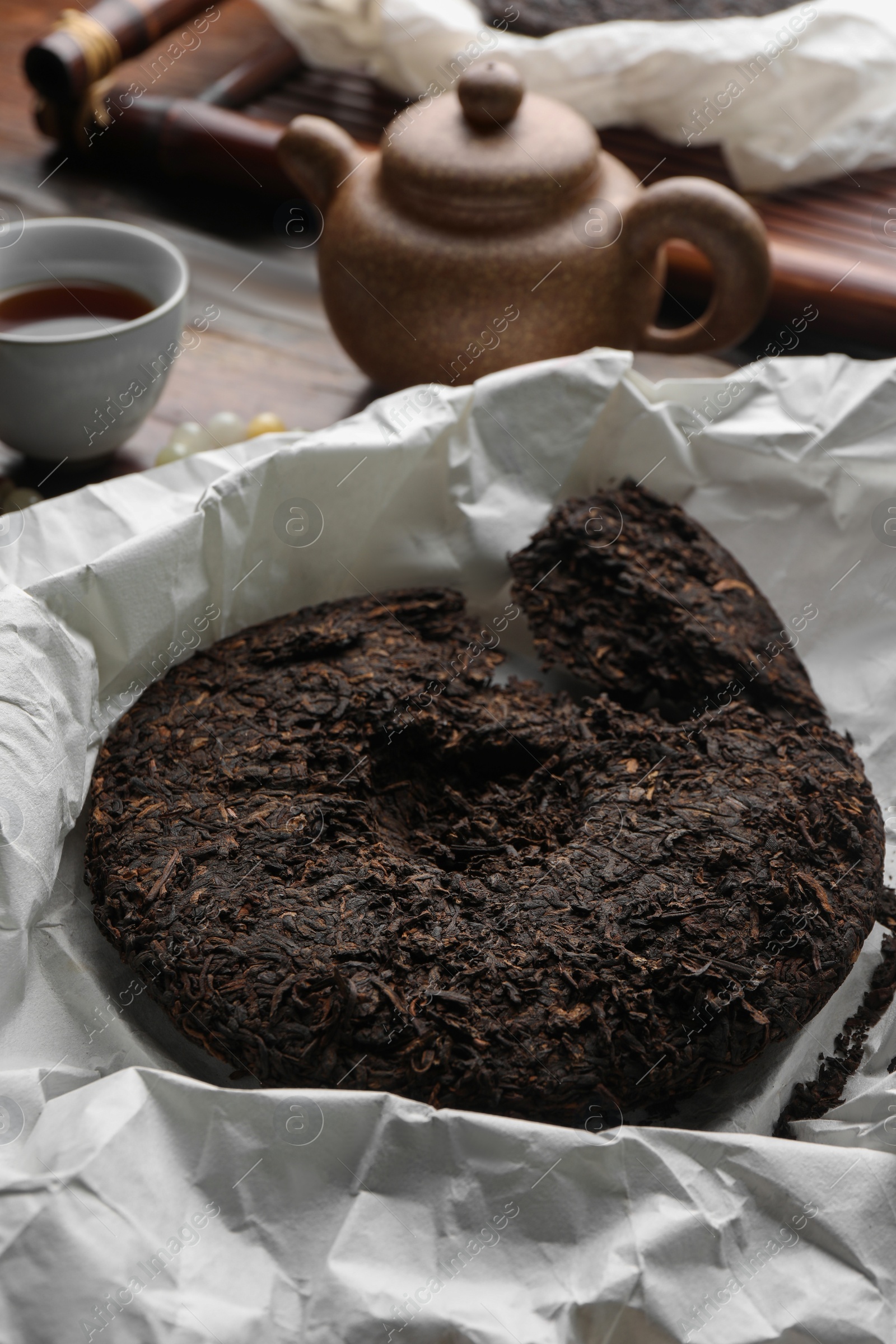 Photo of Broken disc shaped pu-erh tea on parchment paper