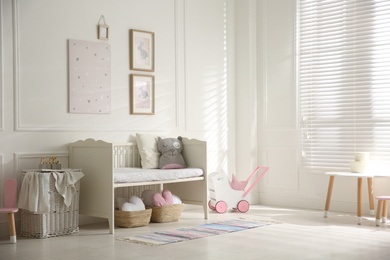 Photo of Baby room interior with stylish furniture and toys