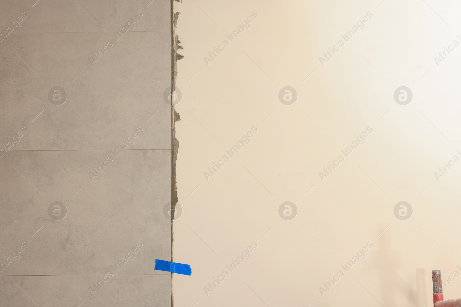 Photo of Adhesive mix with tiles on white wall