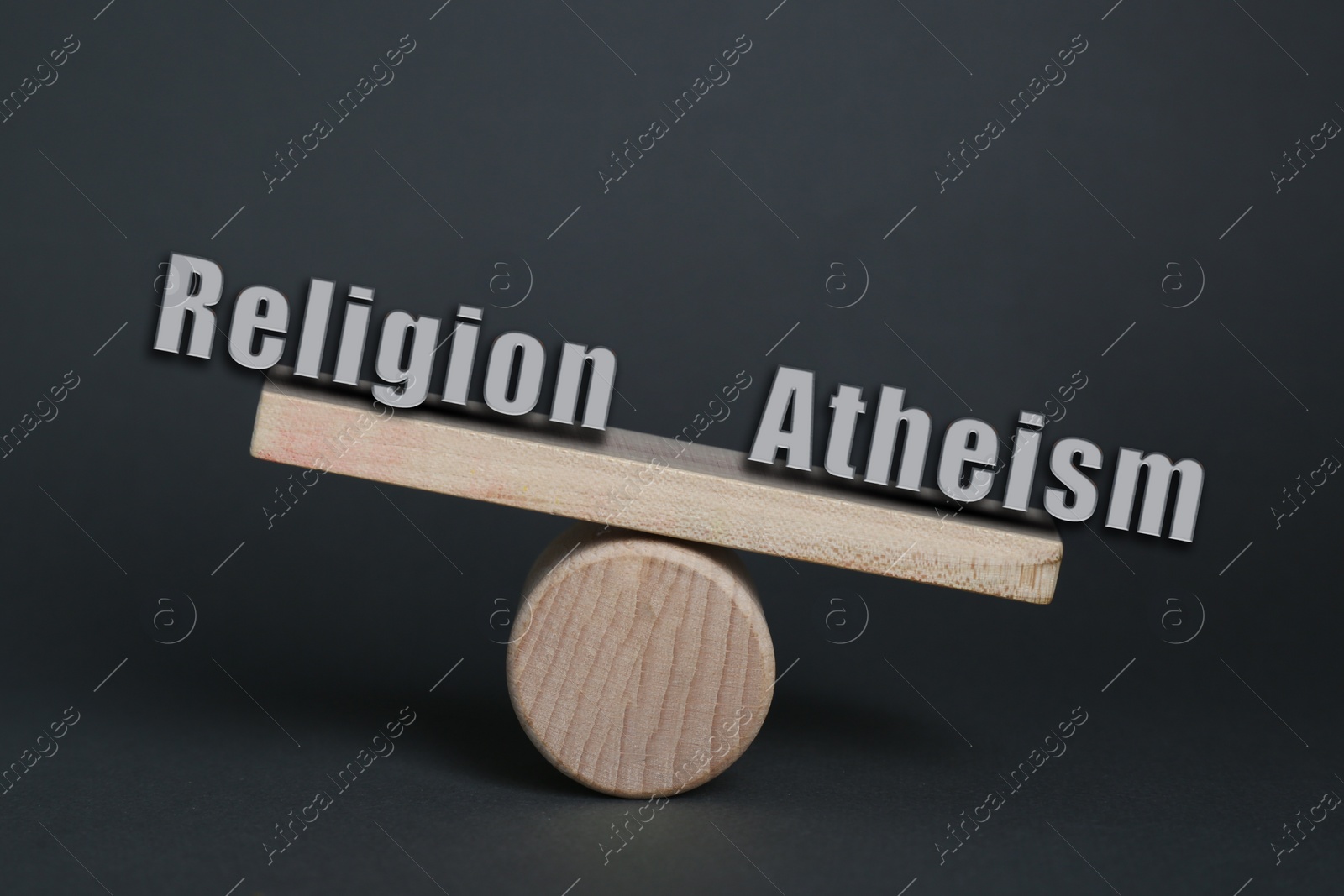 Image of Choice between atheism and religion. Miniature wooden seesaw with words on dark grey background