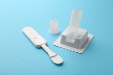 Photo of Disposable express test kit on light blue background