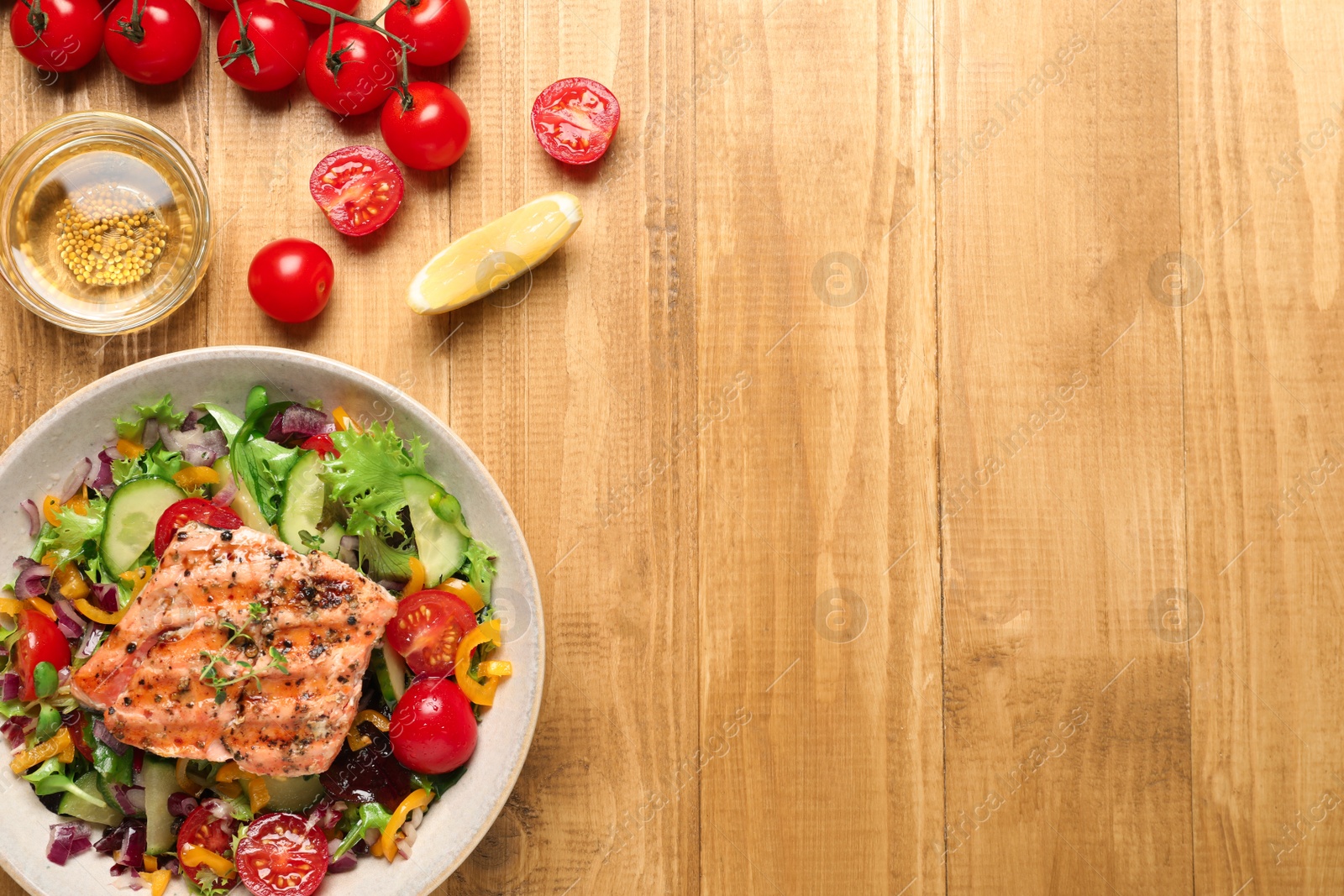 Photo of Bowl with tasty salmon and mixed vegetables on wooden table, flat lay. Space for text