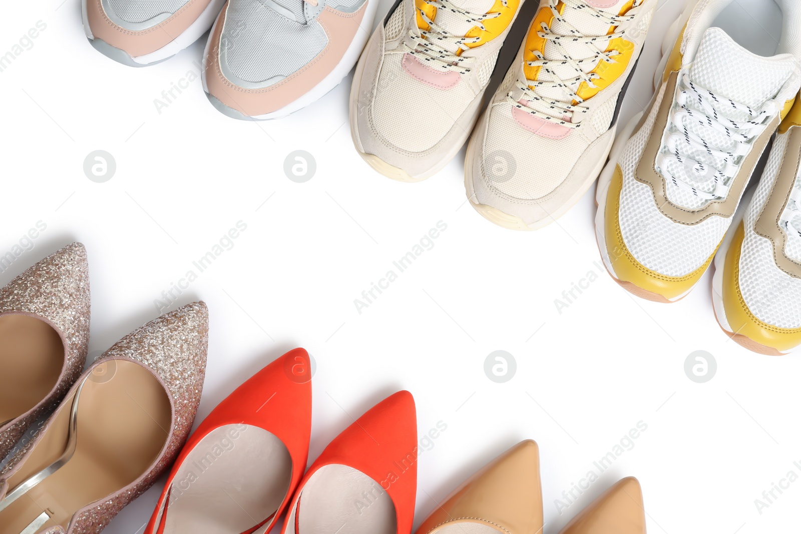 Photo of Frame of different shoes on white background, top view with space for text