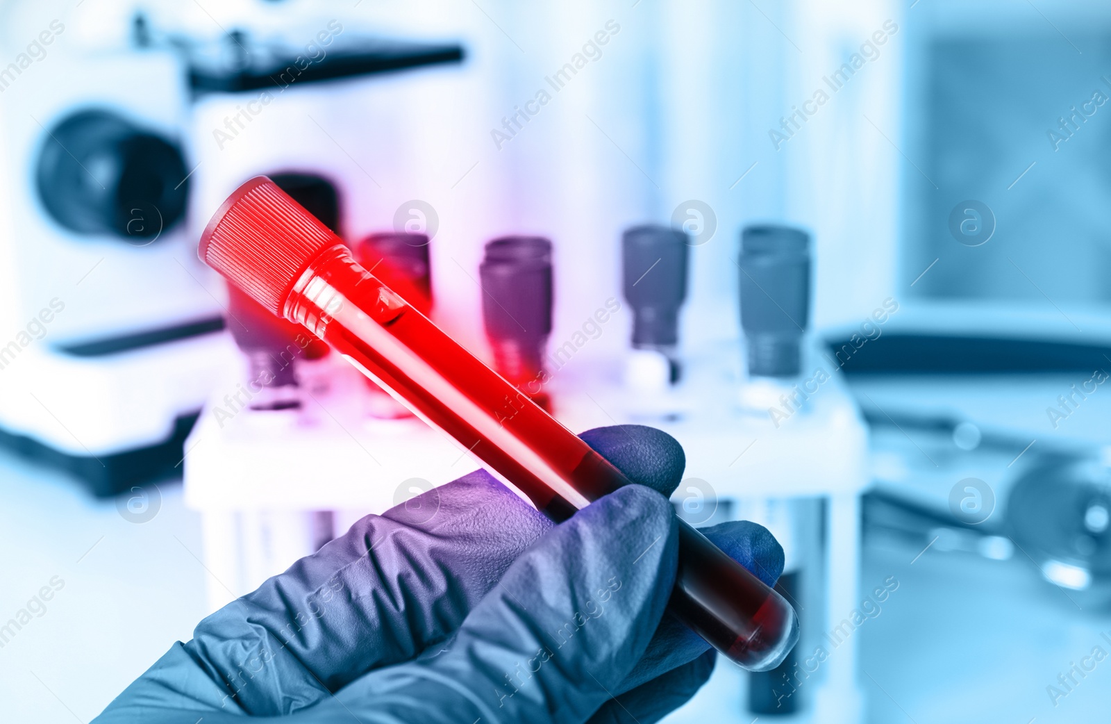 Image of Scientist holding test tube with blood sample, closeup. Laboratory analysis