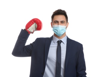 Photo of Businessman with protective mask and boxing gloves on white background. Strong immunity concept