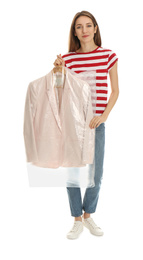 Young woman holding hanger with jacket in plastic bag on white background. Dry-cleaning service