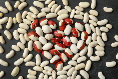 Photo of Raw beans on black background, flat lay. Vegetable seeds