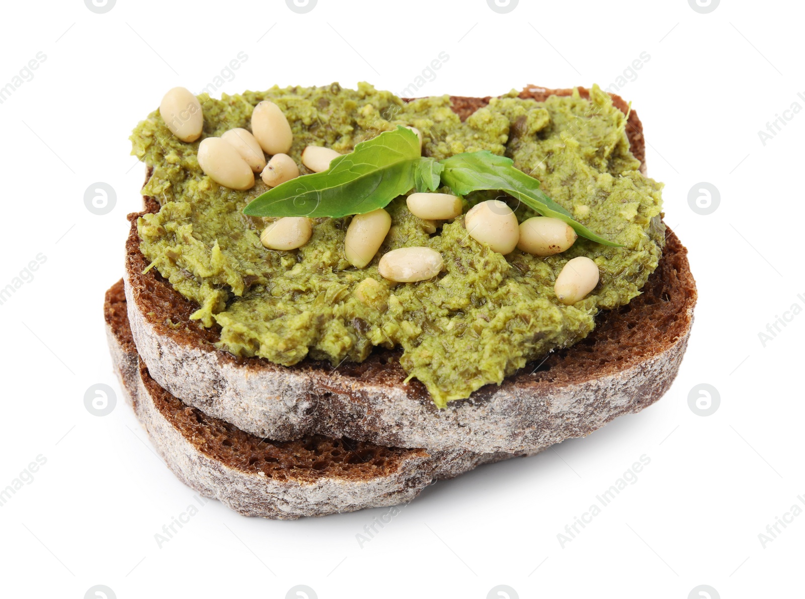 Photo of Tasty bruschetta with pesto sauce, nuts and fresh basil isolated on white