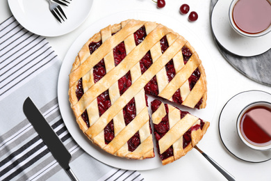 Photo of Delicious fresh cherry pie served on white table, flat lay