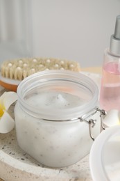 Photo of Jar of exfoliating salt scrub on tray