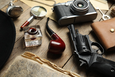 Photo of Composition with different vintage items on wooden table. Detective's workplace