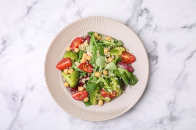 Photo of Healthy meal. Tasty salad with quinoa, chickpeas and vegetables on white marble table, top view