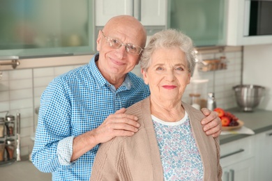 Portrait of happy elderly couple in kitchen