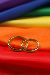 Photo of Wedding rings on rainbow LGBT flag, closeup