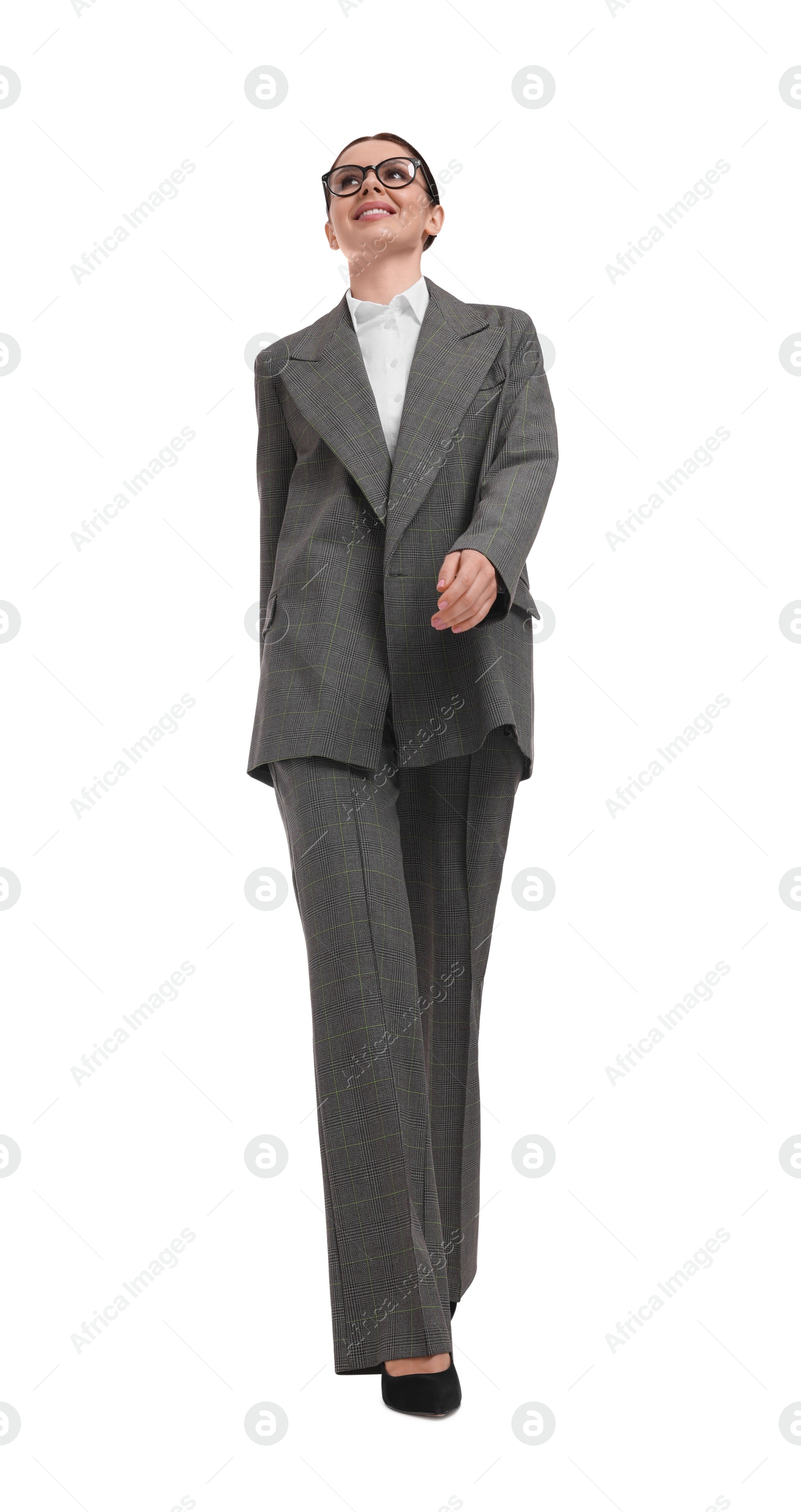 Photo of Beautiful businesswoman in suit walking on white background