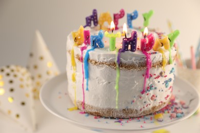 Photo of Tasty Birthday cake with burning candles on table, closeup