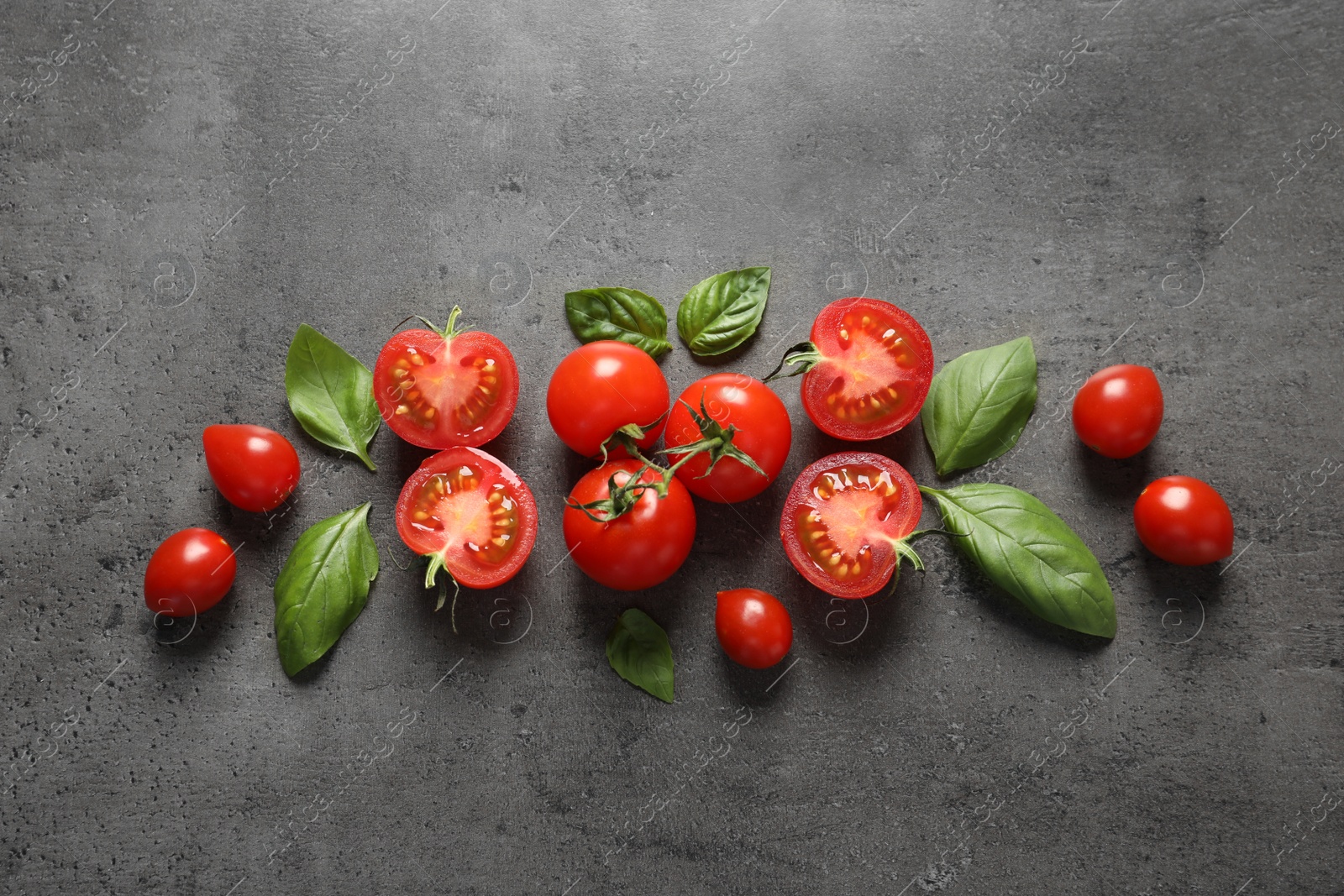 Photo of Flat lay composition with ripe cherry tomatoes and basil leaves on color background