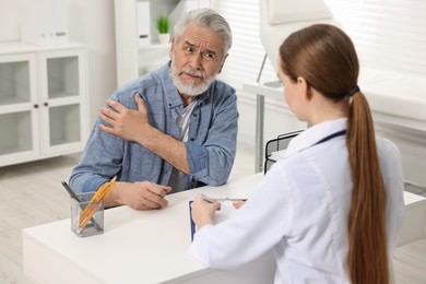 Photo of Arthritis symptoms. Doctor consulting patient with shoulder pain in hospital