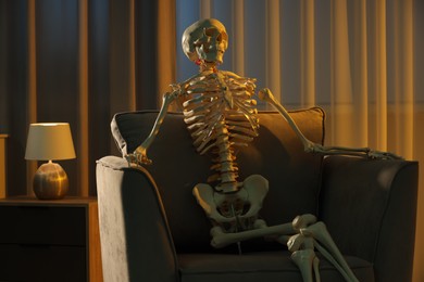 Waiting concept. Human skeleton sitting in armchair indoors