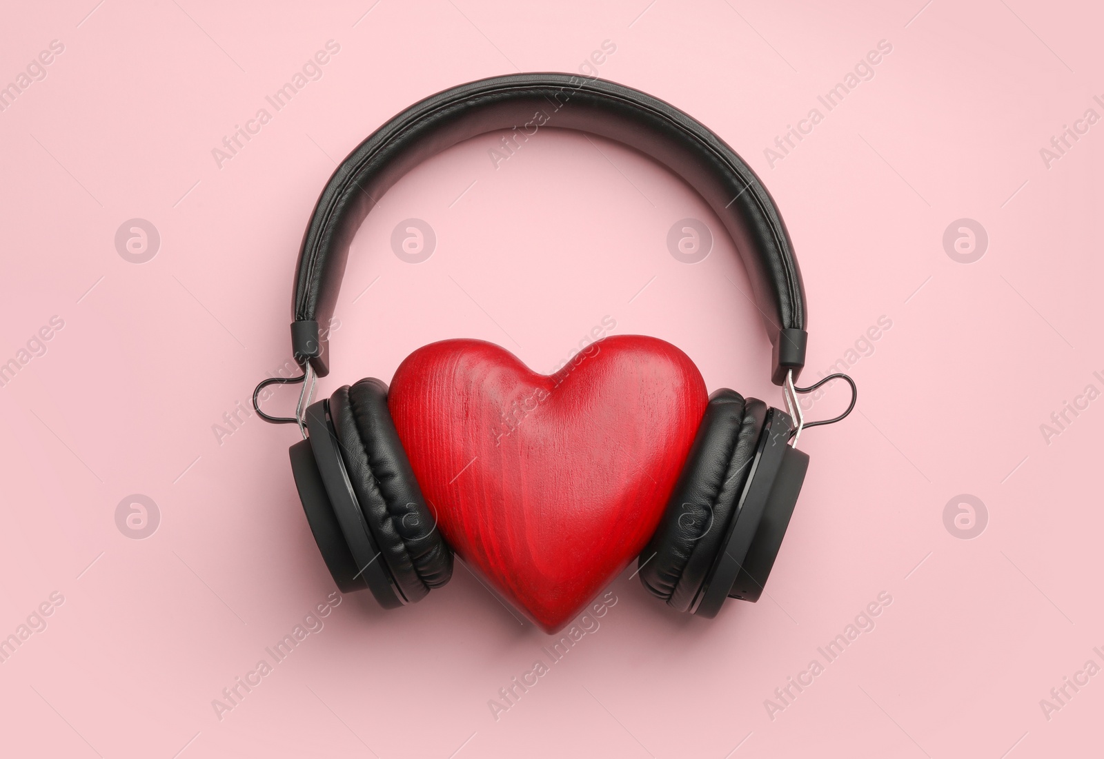 Photo of Decorative heart and modern headphones on color background, flat lay