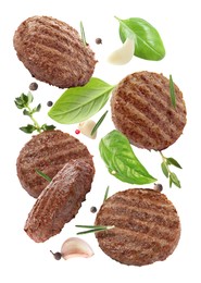 Image of Tasty grilled hamburger patties and spices falling on white background
