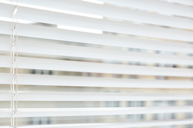 Window with modern horizontal blinds indoors. Space for text