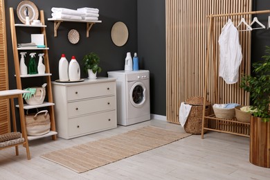 Laundry room interior with washing machine and furniture