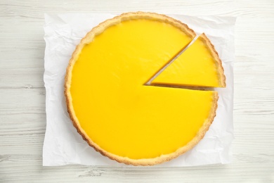 Photo of Delicious homemade lemon pie on white wooden table, top view