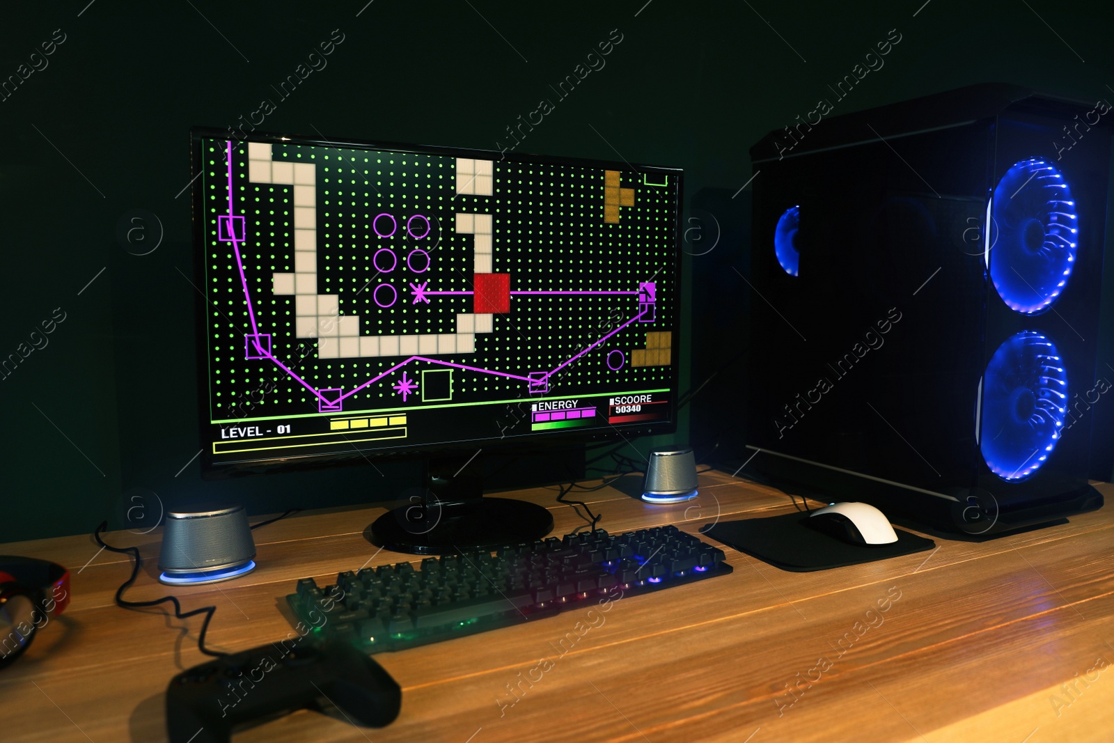 Photo of Modern computer and RGB keyboard on wooden table in room